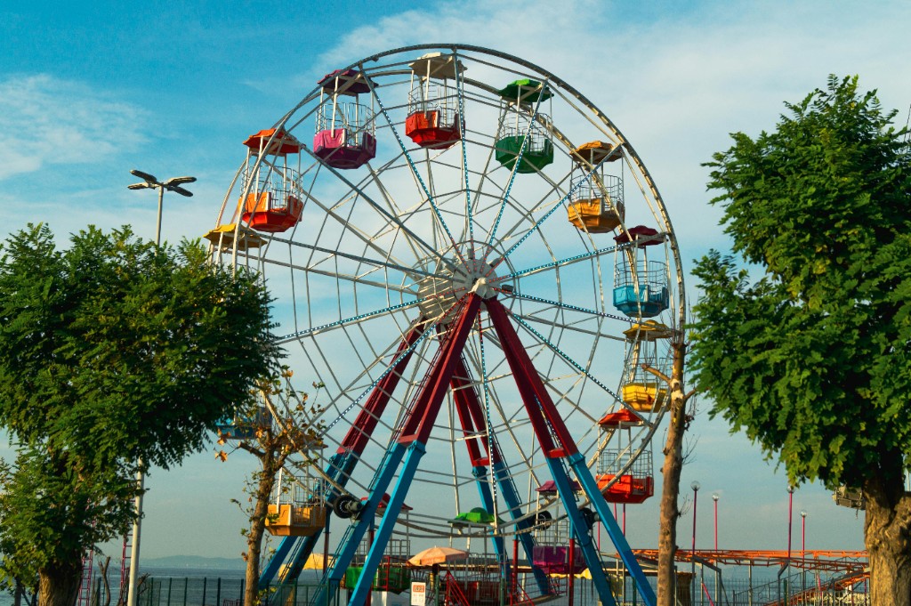 Colourful ferris wheel at a funfair on a sunny day