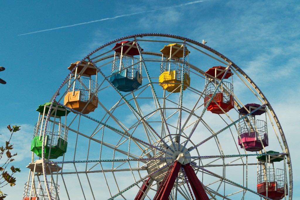 Colourful ferris wheel against a bright blue sky
